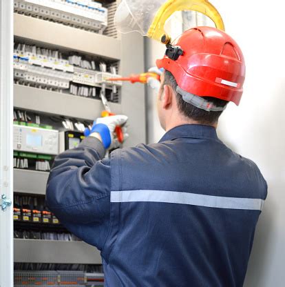 How much does an electrician cost in the uk? Electrician Working With Work Tool In Electrical Room ...