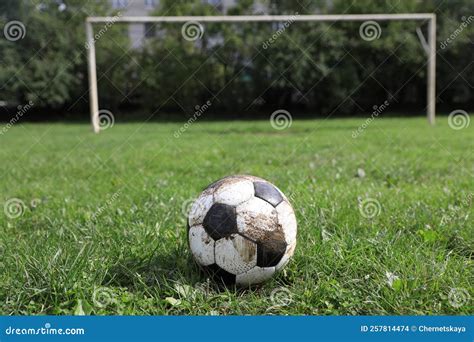 Dirty Soccer Ball On Green Grass Outdoors Space For Text Stock Photo