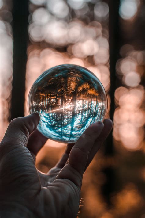 Close Up Photo Of Person Holding Crystal Ball · Free Stock Photo