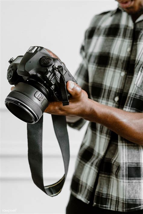 Download Premium Image Of Male Photographer Holding A Camera By