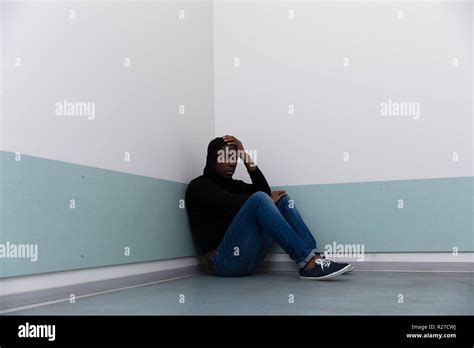 Depressed African Man Sitting Alone On Floor Stock Photo Alamy