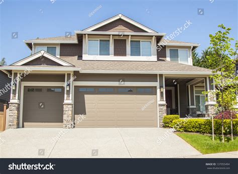 Perfectly Manicured Suburban House On A Beautiful Sunny Day Stock Photo