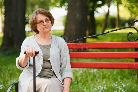 An Elderly Woman Sitting On Bench In Summer Park Stock Photo Image Of