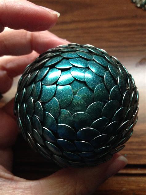 Decorate with beads, jewels, and seashells by pushing them into clay. How to make a dragon egg with nail polish and thumb tacks ...