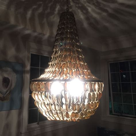 I've seen these little decorations on things like windchimes at souvenir shops but never knew what they were called. I would LOVE to DIY this oyster shell chandelier for my ...
