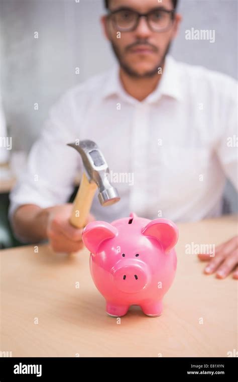 Man Breaking Piggy Bank With Hammer Stock Photo Alamy