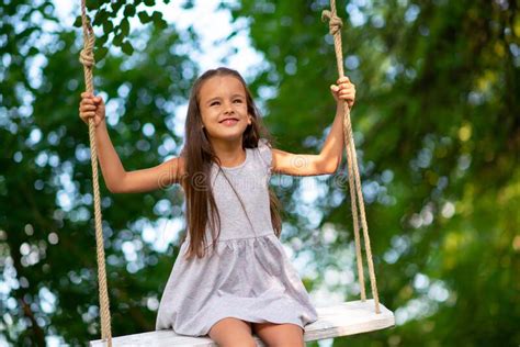 Happy Girl Rides On A Swing In Park Little Princess Has Fun Outdoor Summer Nature Outdoor