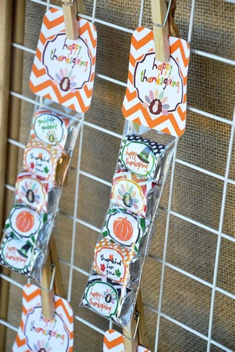 Some Orange And White Tags Hanging From Clothes Pins
