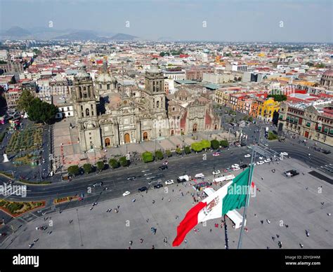 Mexico National Flag On Zocalo Constitution Square And Metropolitan
