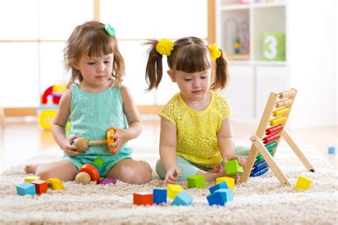 Children Playing Together With Building Blocks Educational Toys For