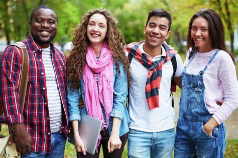 Portrait Of Happy College Students Standing Together Outdoors Stock