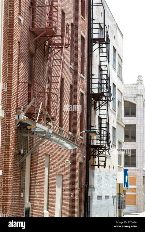 Old Fire Escapes Are Attached To The Exterior Of Brick Buildings In