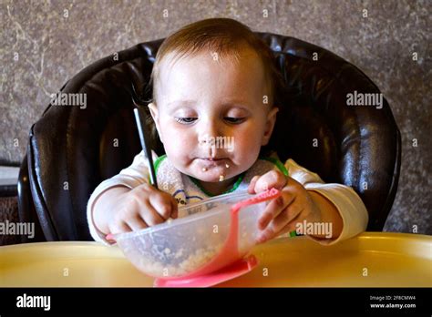 Baby Girl Eating Porridge From A Bowl Stock Photo Alamy