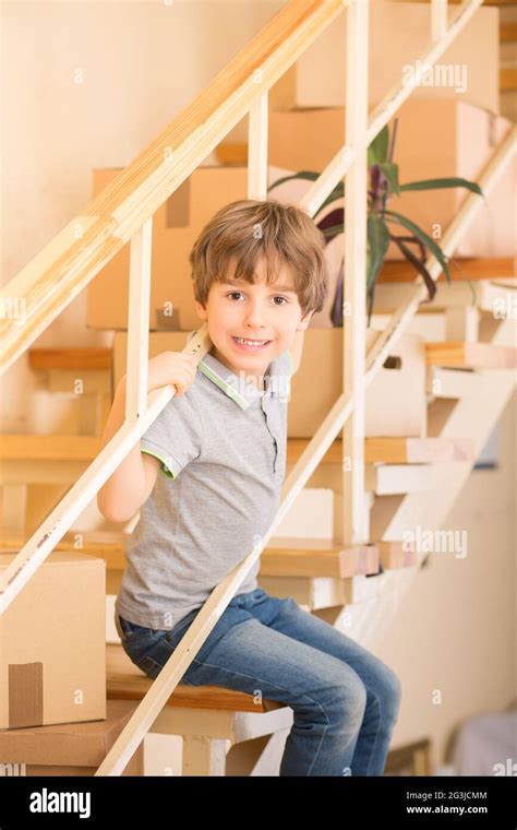 Little Boy Sitting On Stairs Indoors Stock Photo Alamy