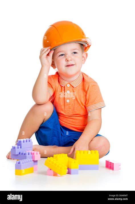 Cheerful Child Boy With Hard Hat Playing With Building Blocks Toys Over