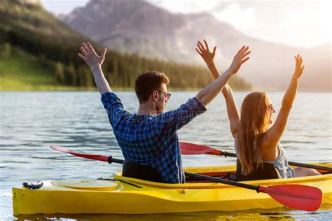 Couple Kayaking On River With Sunset On Background Stock Image Image