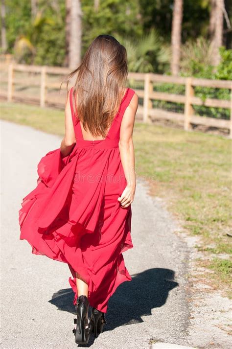 Woman In A Red Dress Walking Away Stock Photo Image Of Pretty