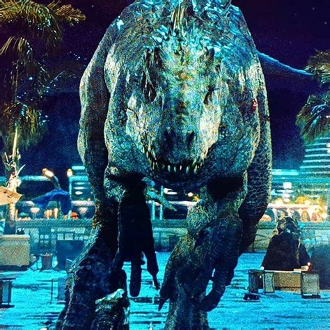 A Large Dinosaur Walking Through A City At Night