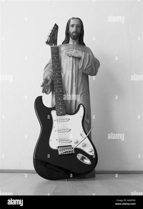 Statue Of Jesus With Electric Guitar Leaning Against It Stock Photo Alamy