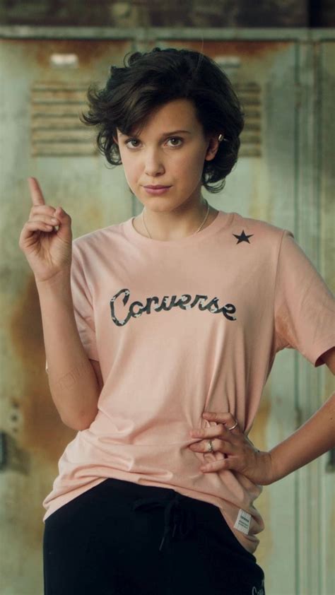 Download Millie Bobby Brown In A Casual Converse Shirt Wallpaper