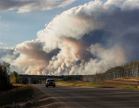 Smoke Billows From The Fort Mcmurray Wildfires Truck Drives Down The