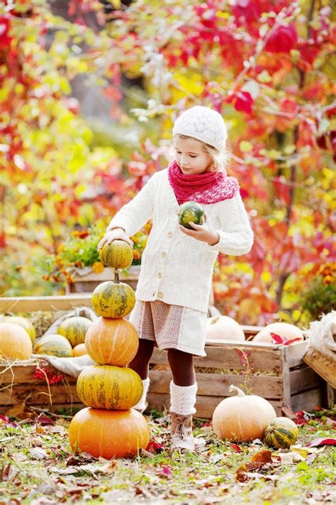 Cute Little Girl Playing With Pumpkins In Autumn Park Autumn