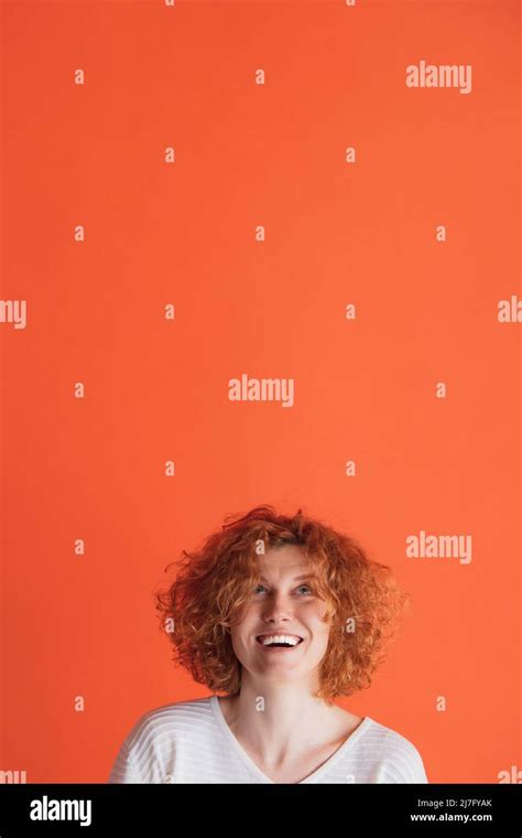 Portrait Of Happy Looking Red Haired Woman Cheerfully Posing Looking