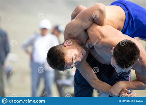Two Young Men Wrestling Outdoors Editorial Photography Image Of