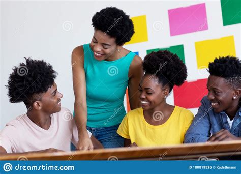 African American Female Tutor Learning With Students Stock Image