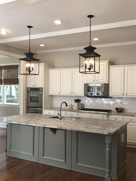 Brown wooden flooring, orange accessories and a backsplash with hues of light grey and cream all warm up this grey kitchen nicely. Walls - BM Stonington Gray Cabinets, Trim, Ceiling - BM ...