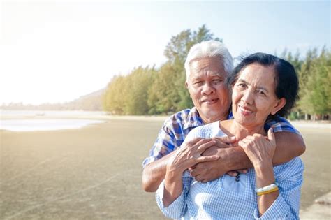 Premium Photo Asian Elderly Couple Hugging Each Other By The Sea