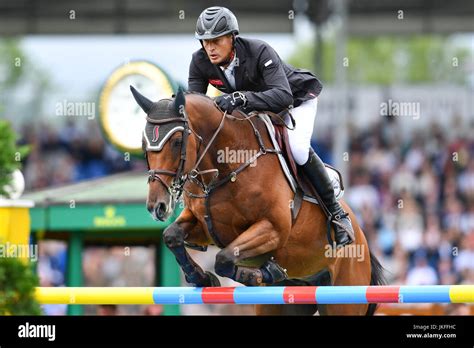 Dutch Show Jumper Marc Houtzager Jumping Over An Obstacle On His Horse