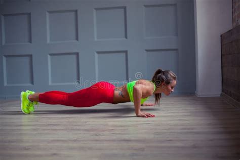 Beautiful Fitness Woman Is Doing Push Ups In The Gym Stock Photo