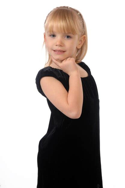 Premium Photo Photo Of A Little Girl In A Black Dress Posing On Camera