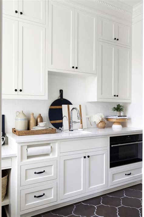 There's a beautiful center island also with a black granite counter, a raised area for people to eat on and open shelves at one end. Modern Tudor Pt. I | White shaker cabinets, Cheap home ...