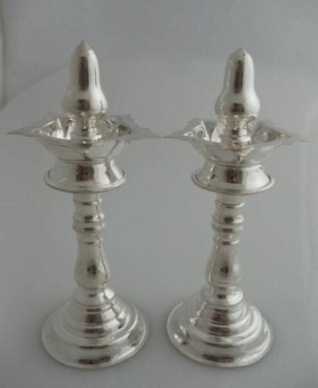 Silver tabeez / amulets, silver yonibase with shivling, gift items made in silver for marriage, online shop for silver coins, buy idols and statues of god and goddess in pure silver. Pure Silver Oil Lamps - Indian Pooja Oil Lamps