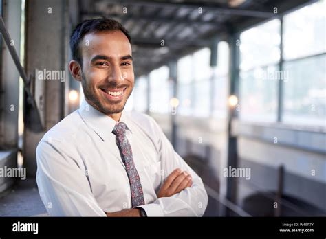 Indian Businessman Smiling Confidently With Cityscape Background Stock