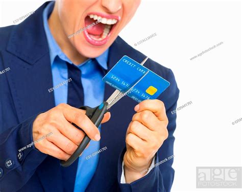 Closeup On Angry Business Woman Cutting Credit Card With Scissors