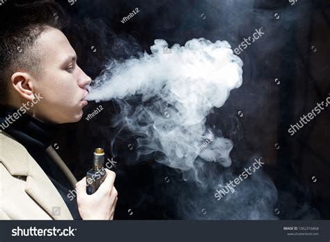 Young Guy Smokes Exhales Cloud Smoke Stock Photo 1062316868 Shutterstock