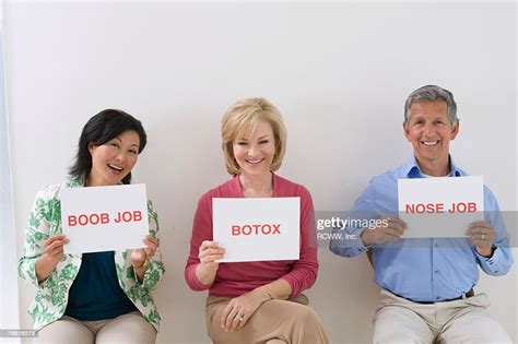 People Holding Up Signs Of Different Vanity Procedures High Res Stock