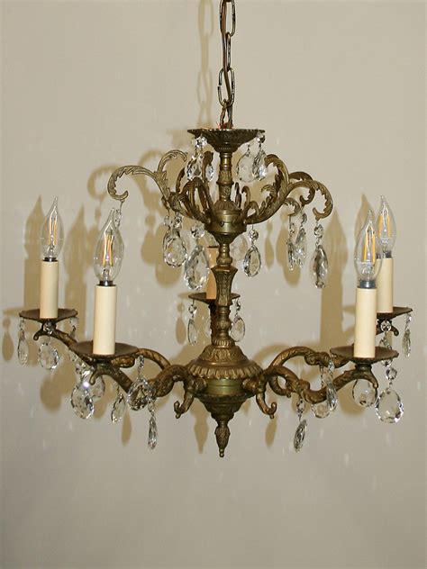 Silver chandeliers from the coated crystal product range are made of components coated with noble metal. Vintage Brass & Crystal Chandelier w/ Leaf Details, c. 1950