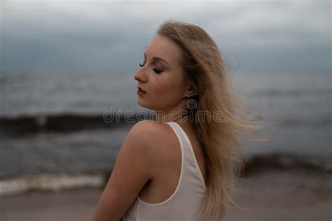 Close Up Portrait Of Beautiful Young Blonde Woman Beach Nymph In White Dress Near Sea With Waves