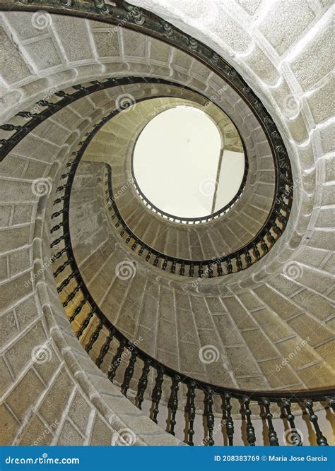 Beautiful Stone Spiral Staircase With Wooden Railings Stock Image
