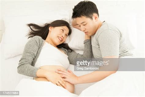 Husband Touching Wifes Pregnant Stomach In Bed Photo Getty Images