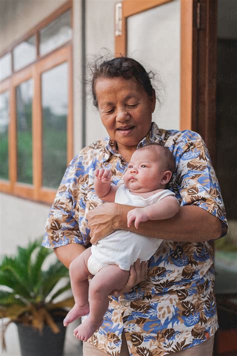 Grandmother Holding Her Grandson By Stocksy Contributor Chalit