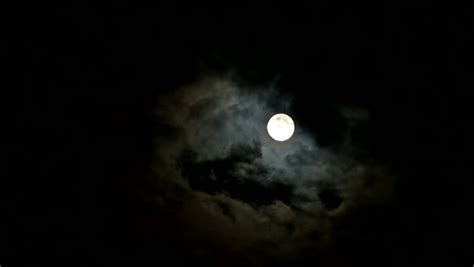 Bright Full Moon With Passing Clouds At Night In Real Time Stock