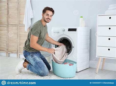 Young Man Using Washing Machine At Home Stock Image Image Of Clothes Equipment 134343257
