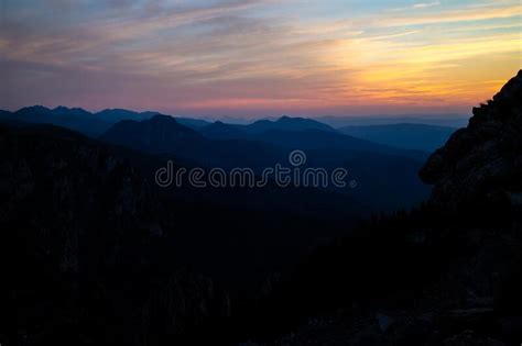 Blue Silhouettes Of Carpathian Rocky Mountains And Sunset Orange Blue