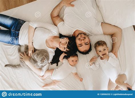 Overhead View Of Smiling Parents With Two Sons And Grey