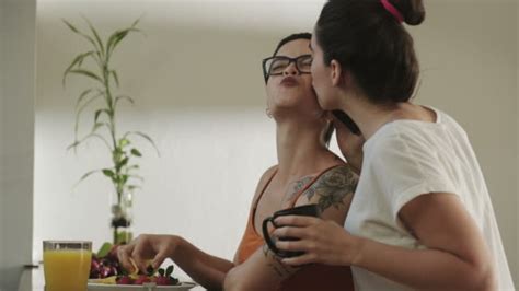 20 Young Lesbian Couple Washing And Wiping Utensils In Kitchen Stock